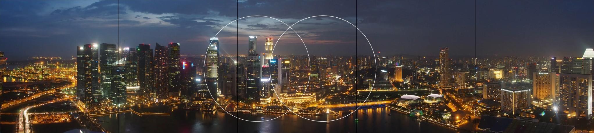 Storyboard frame: the city skyline with the portraits and feeds gone, leaving two large overlapping translucent circle outlines in the centre of the wall where the mark sits
